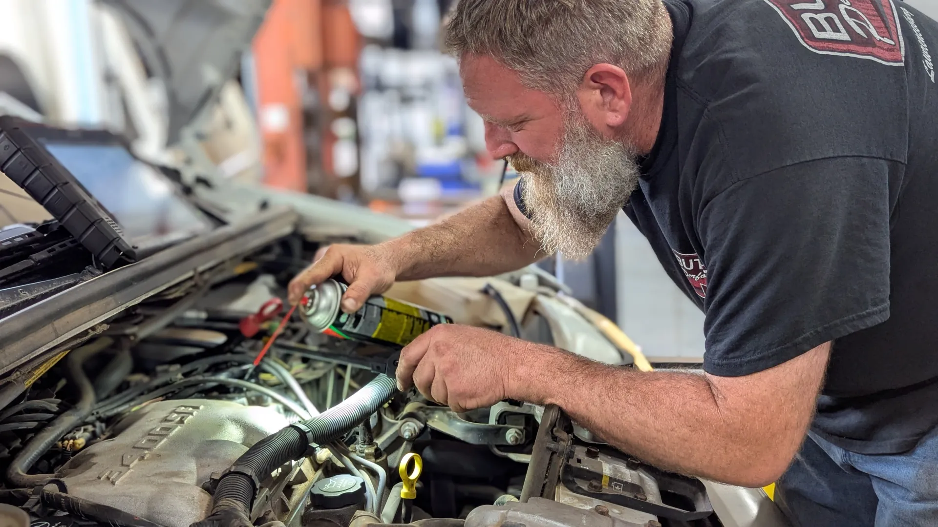 Patriot Garage technician performing full vehicle inspection in Tulsa